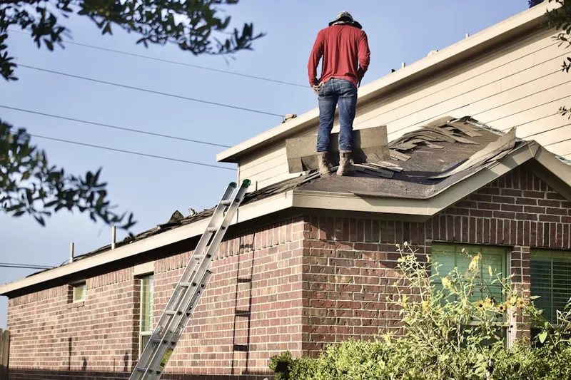 Professional roofer working on a residential roof in Coral Gables Estates